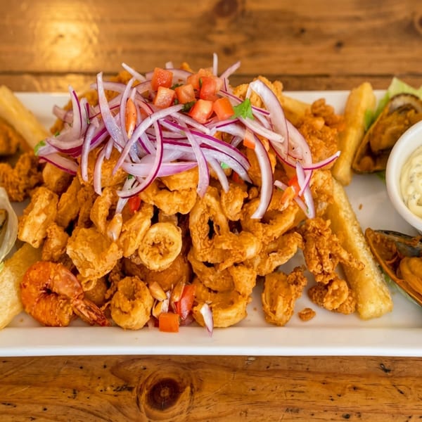 Crispy fried calamari, shrimp, and yuca fries topped with red onion and tomato salsa.